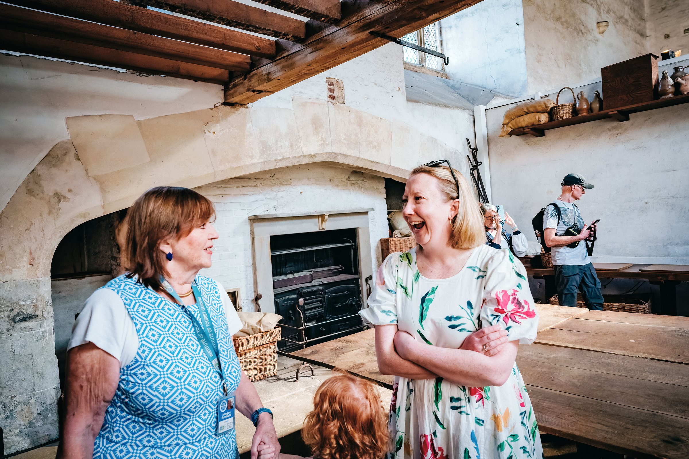 A visitor enjoying the explanation of the historical Tudor kitchens