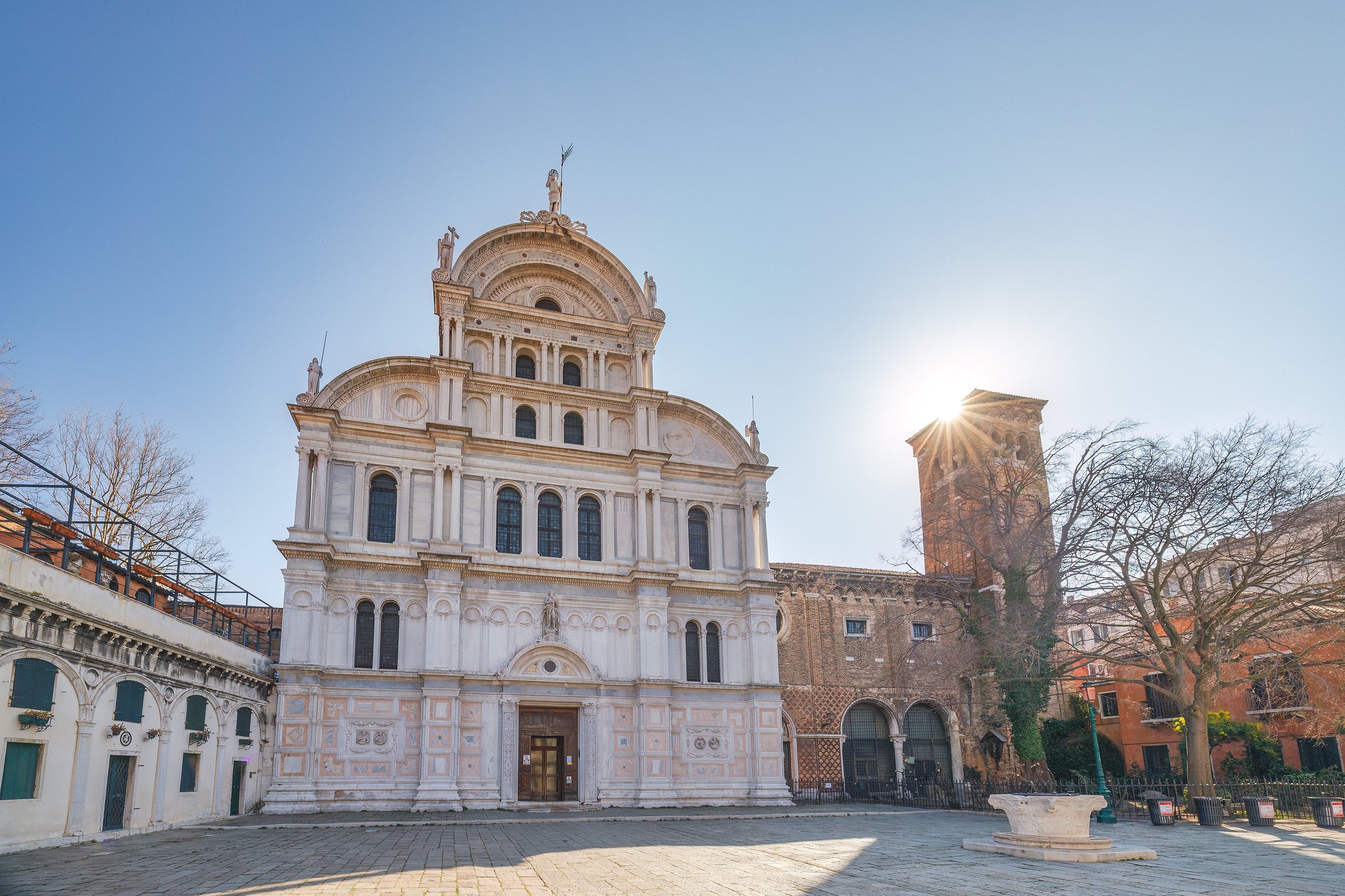 Morning sun peeks behind Venice’s Church of San Zaccaria, lighting its Renaissance façade and quiet square.